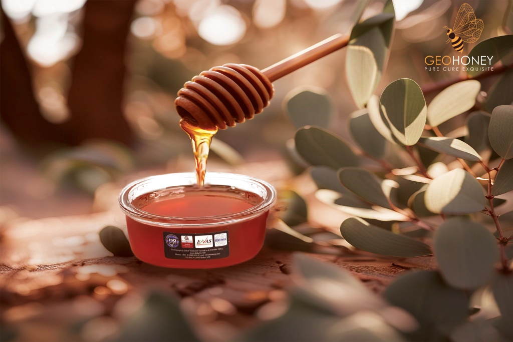 eucalyptus honey jar, showcasing its vibrant colour and enticing texture, eucalyptus blossoms adorn the background.
